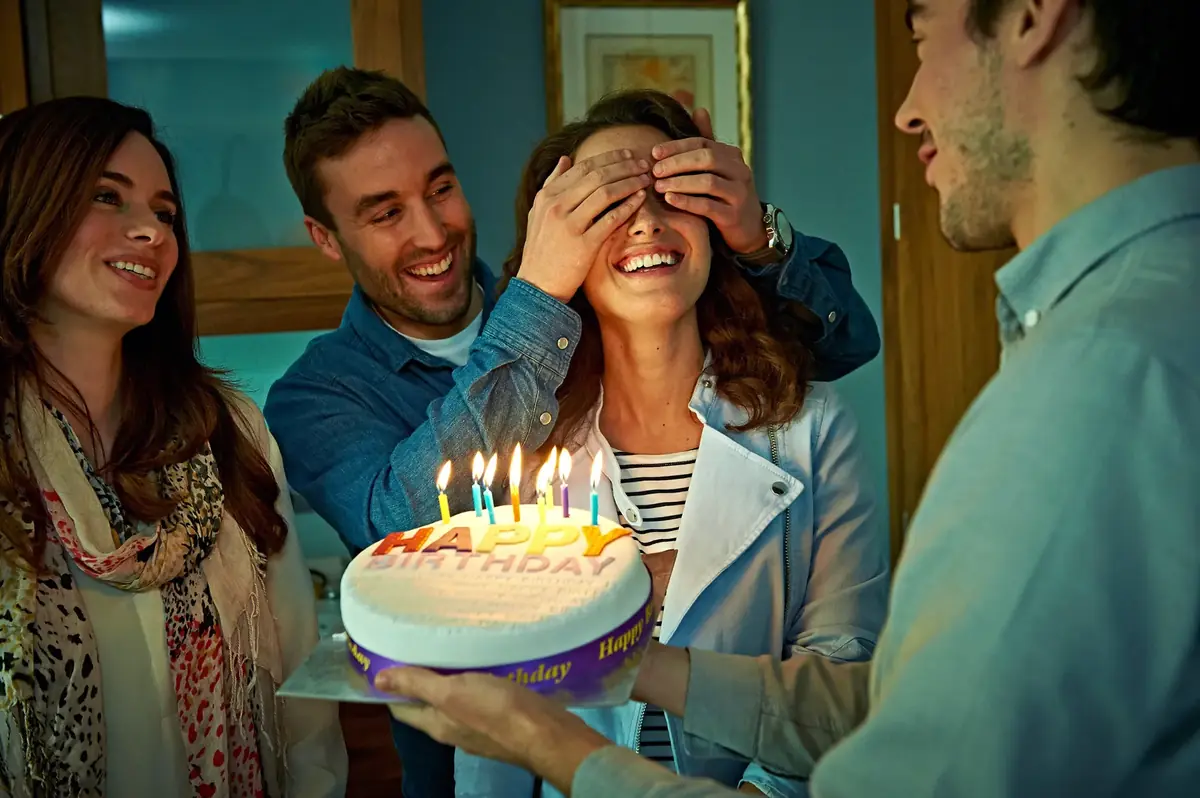 Surprise birthday party with friends and a birthday cake